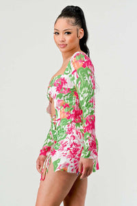 Bold Floral Print Mini Dress with Cut-Outs: This mini dress features a striking floral print in pink, green, and white, with a twist-front cut-out design at the bust. It also has long sleeves and ruched detailing with a drawstring on the side.