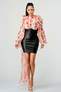 Blossom Leatherette Mini Dress," an exquisite fusion of edgy modernity and romantic florals. This dress showcases a striking contrast with its vibrant floral print from the waist up, creating an aura of a blossoming garden, while the sleek leather-like detail from the waist down adds a bold, contemporary edge -
Rêve Dorés