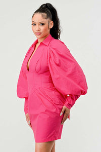 Puff Sleeve Dress - Statement sleeves add vintage charm Model wearing a vibrant pink mini dress featuring a deep V-neckline, structured bodice, and dramatic bishop sleeves. The tailored waist and flared silhouette add a touch of elegance and femininity, making it perfect for standout occasions - Rêve Dorés