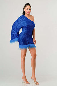 Model wearing a dazzling one-shoulder mini dress in vibrant blue, covered in shimmering sequins and featuring a dramatic single sleeve. The hem and sleeve are accented with matching feathered trim, creating a bold and luxurious look ideal for parties and special occasions - Rêve Dorés