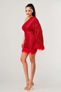 Azure Allure One-Shoulder Dress - Model wearing a glamorous one-shoulder mini dress in vibrant red, adorned with shimmering sequins and featuring a dramatic single sleeve. The hem and sleeve are accented with feathered detailing, adding a bold and luxurious touch, perfect for special occasions or holiday parties. -Rêve Dorés