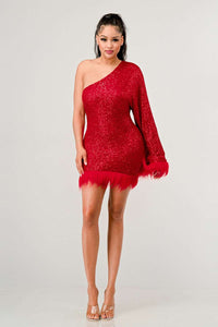 Azure Allure One-Shoulder Dress - Model wearing a glamorous one-shoulder mini dress in vibrant red, adorned with shimmering sequins and featuring a dramatic single sleeve. The hem and sleeve are accented with feathered detailing, adding a bold and luxurious touch, perfect for special occasions or holiday parties. -Rêve Dorés