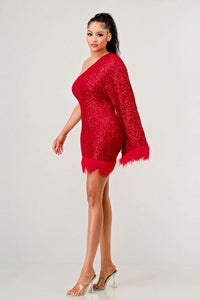 Azure Allure One-Shoulder Dress - Model wearing a glamorous one-shoulder mini dress in vibrant red, adorned with shimmering sequins and featuring a dramatic single sleeve. The hem and sleeve are accented with feathered detailing, adding a bold and luxurious touch, perfect for special occasions or holiday parties. -Rêve Dorés