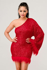 Azure Allure One-Shoulder Dress - Model wearing a glamorous one-shoulder mini dress in vibrant red, adorned with shimmering sequins and featuring a dramatic single sleeve. The hem and sleeve are accented with feathered detailing, adding a bold and luxurious touch, perfect for special occasions or holiday parties. -Rêve Dorés