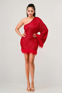 Azure Allure One-Shoulder Dress Model wearing a glamorous one-shoulder mini dress in vibrant red, adorned with shimmering sequins and featuring a dramatic single sleeve. The hem and sleeve are accented with feathered detailing, adding a bold and luxurious touch, perfect for special occasions or holiday parties. - Rêve Dorés