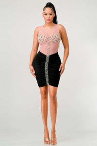 The bodice showcases an embellished bow design made of pearls and rhinestones, centered on the chest