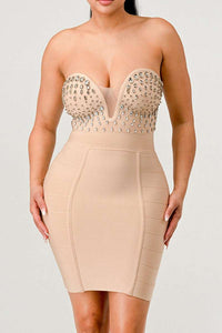 Elegant nude mini dress with sparkling rhinestone details on the bodice and a sculpted, body-conscious fit