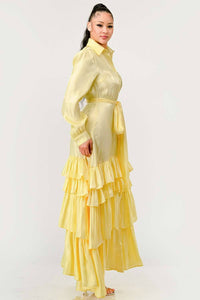 Yellow Collared Maxi Dress with Ruffles: A sophisticated yellow dress with a button-up front, tiered ruffle layers, and a fabric belt. The dress has long sleeves and a collared neckline for a classic look. Rêve Dorés