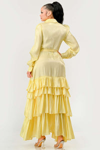 Yellow Long Sleeve Dress with Tiered Skirt: This yellow maxi dress features long puff sleeves, a tiered ruffle skirt, and a collared neckline. The button-up front and waist tie add a touch of elegance. Rêve Dorés