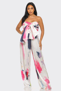 Fashion-forward jumpsuit with a strapless design and statement bow in vibrant abstract print
Rêve Dorés