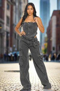 Multi pocket cargo denim jumpsuit. Rêve Dorés Model showcasing a trendy black denim jumpsuit with a strapless design, featuring a belted waist and utility-style pockets for a chic, urban look. The straight-leg fit and rugged detailing make it a perfect statement piece for casual outings or streetwear-inspired ensembles.